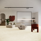 Moquette éco-conçue Infini 11.5 - Crème vanille dans un salon contemporain avec canapé blanc, plante verte et mobilier design