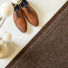 Tapis de passage Antidérapant au mètre - Brun associé à des chaussures en cuir et une décoration aux tons naturels
