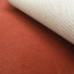 Vue du verso technique de la moquette sur mesure Sylon rouge tomette